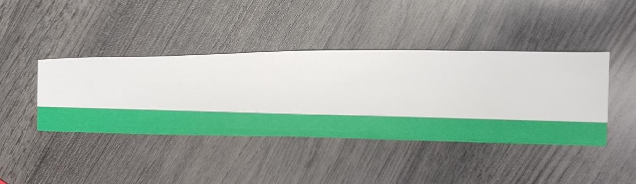 White strip of paper glued to overlap the green strip.