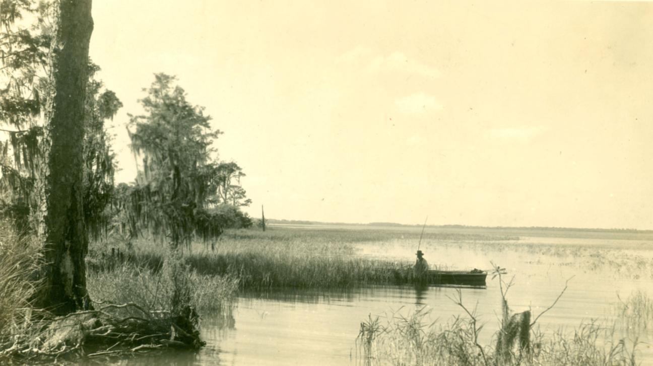 man fishing on boat in the lake