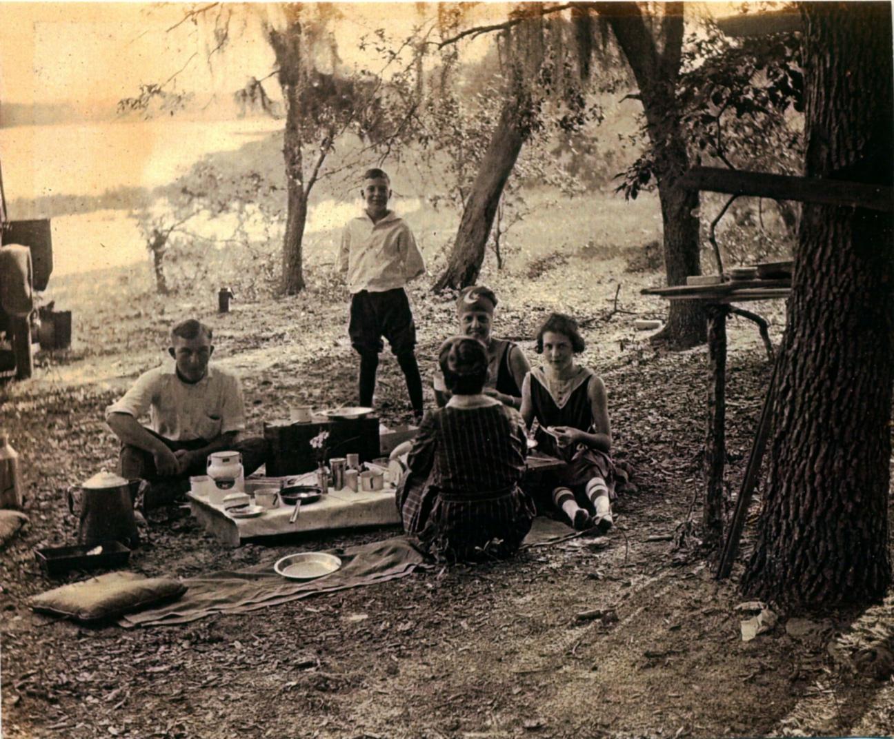 family picnicking by the lake