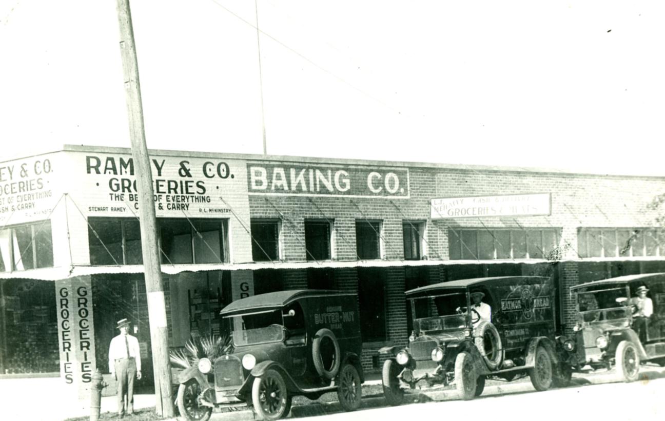 trucks in front of grocery store and bakery 1915