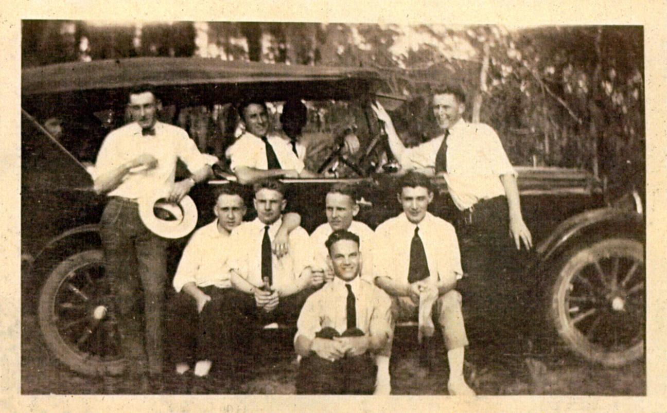 group of men around a Model T car