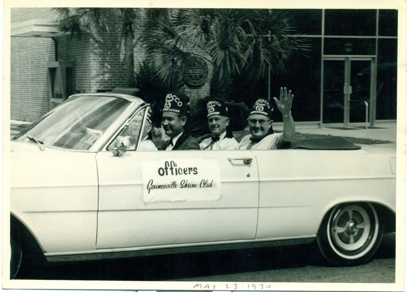 Gainesville Shrine Club members in convertible during parade in 1970