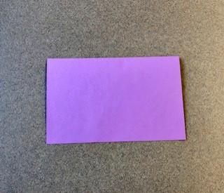 Paper folded in half along the short edge.