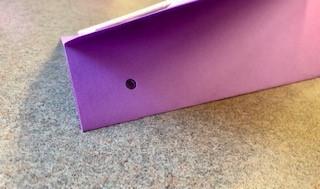 A hole is made in the front end of the kite with a hole puncher