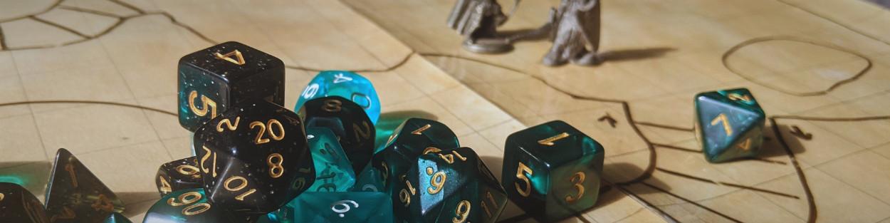 A pile of green, blue, and teal dice on a hand-drawn map, with a d20 reading 20 on top. Two figurines are in the background.