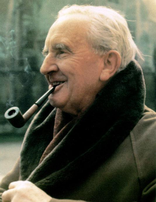 A photo of J.R.R. Tolkien smiling and smoking a pipe.