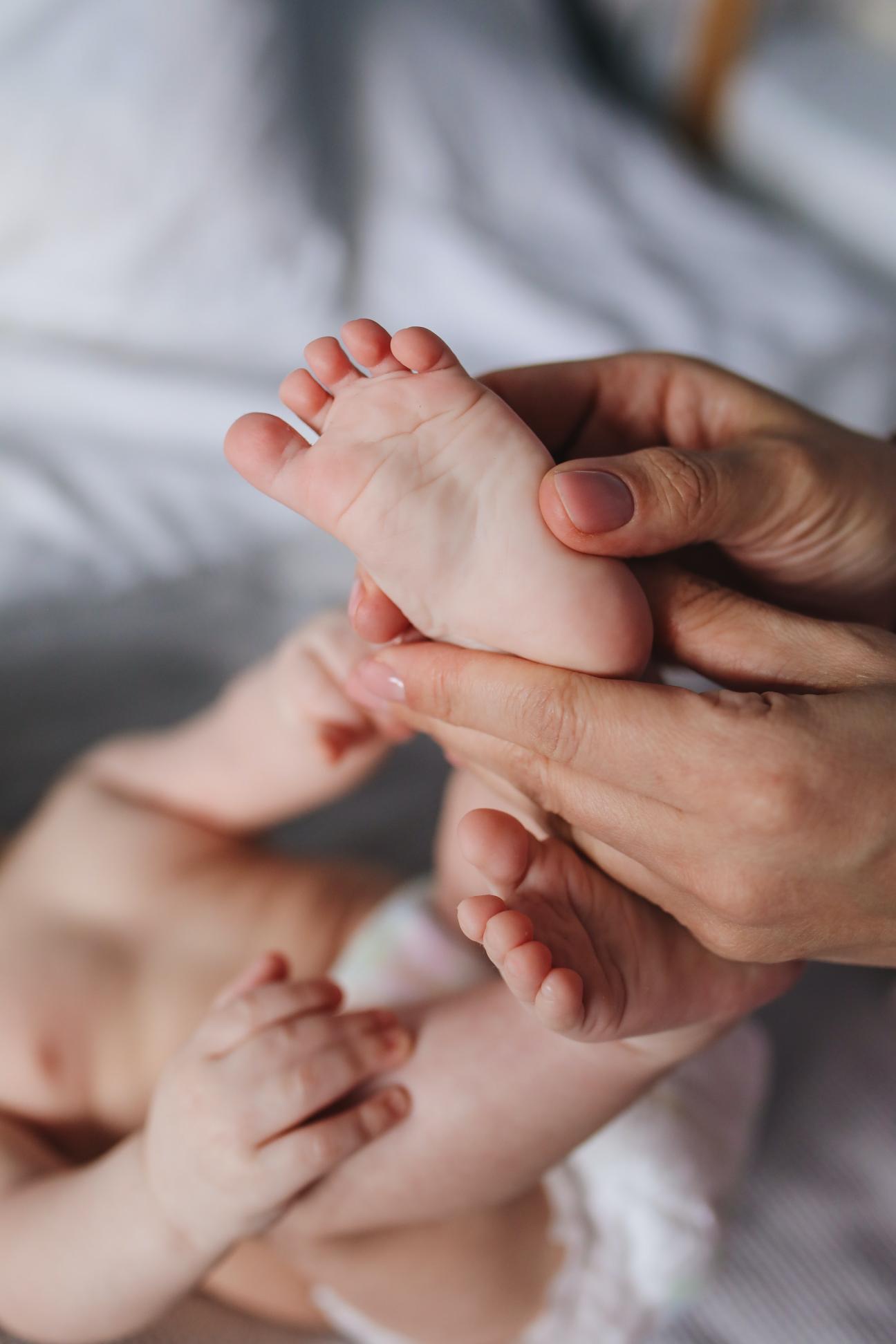 person holding baby's feet