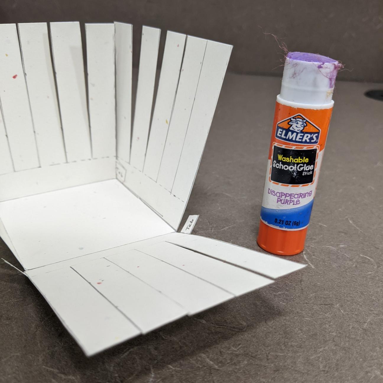 A picture of a paper basket, half glued together