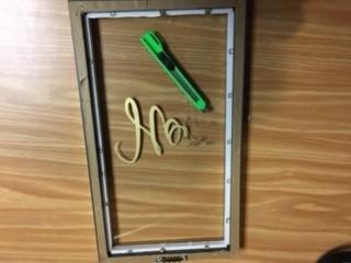 glass inside frame with exacto knife