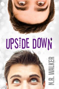 Book cover featuring the two male presenting faces.  One is at the bottom of the image, and only the top half of the face is in frame.  The other face is the same but at the top of the image.  They both have short brown hair and are looking at each other.  The background is white and gray, and text in the middle reads, "Upside Down" in purple stylized font.