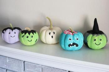 Images of little pumpkins painted as witches, ghosts, & vampires