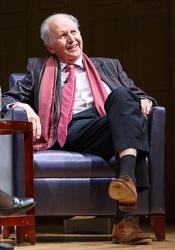 Alexander McCall Smith sitting in chair